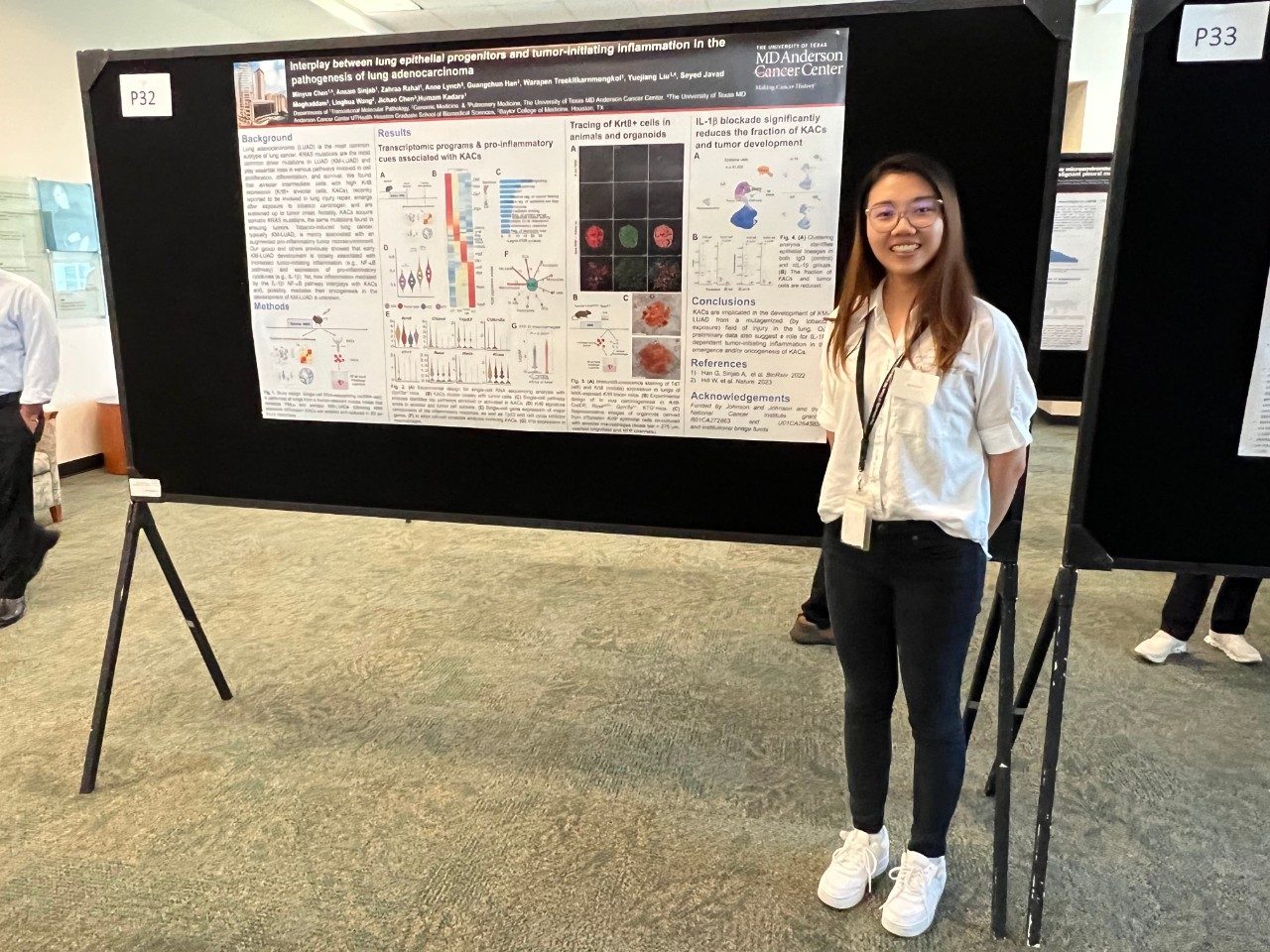 A lab member standing in front of their poster