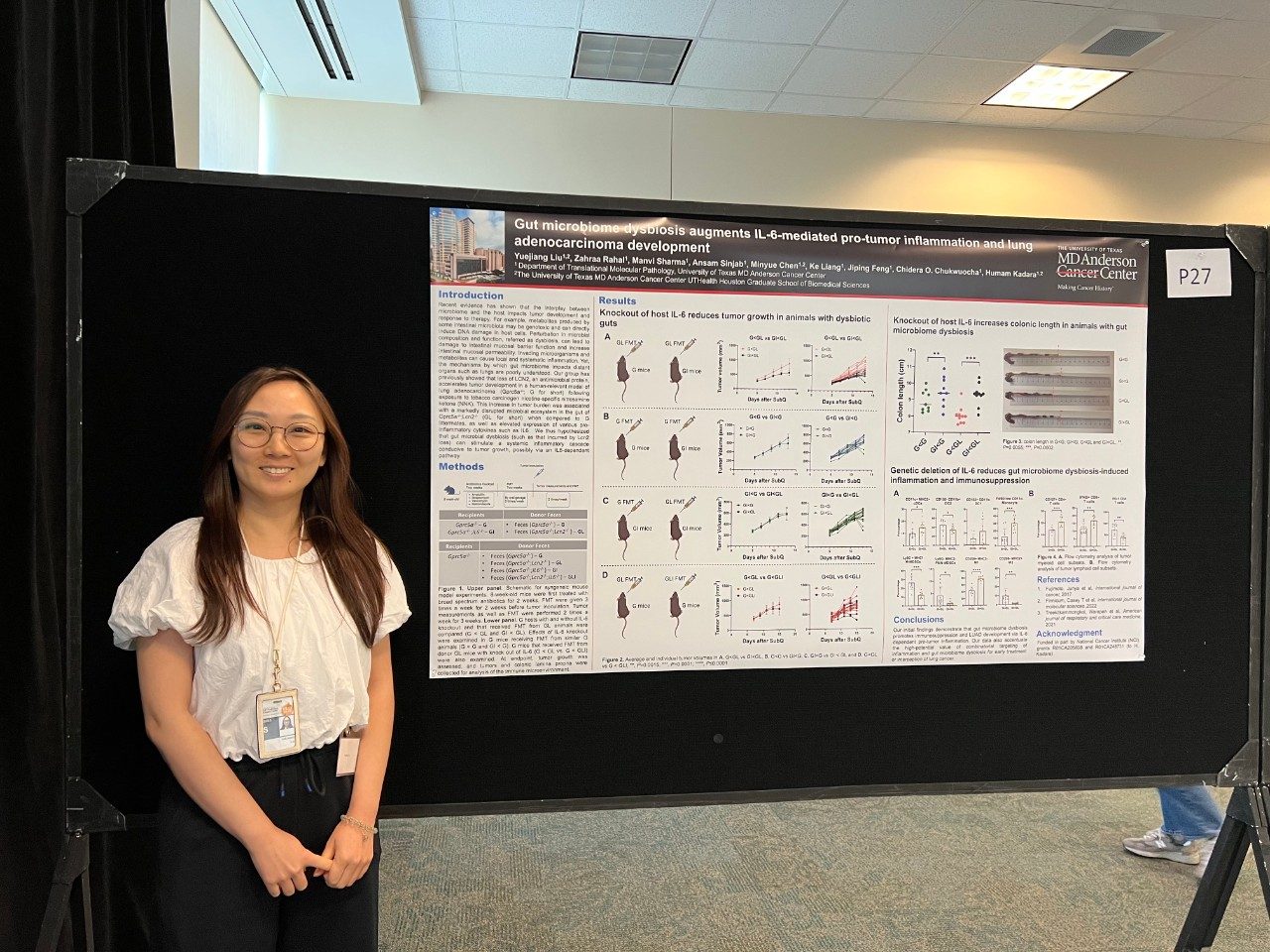 A lab member standing in front of their poster