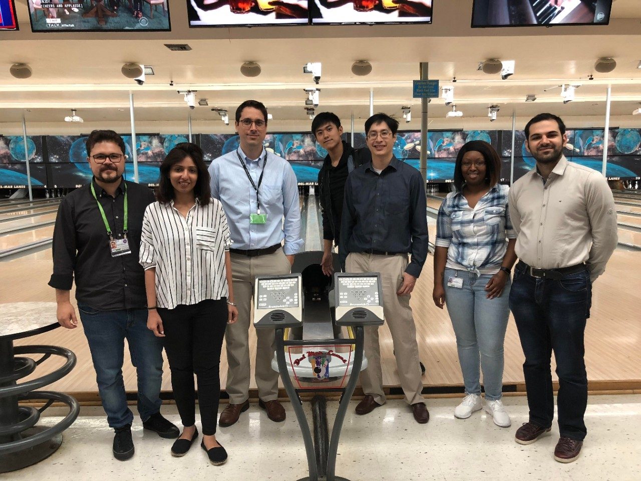 Posed group photo in front of lanes at a bowling alley