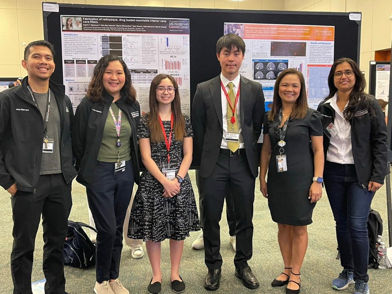 People stand in front of scientific posters