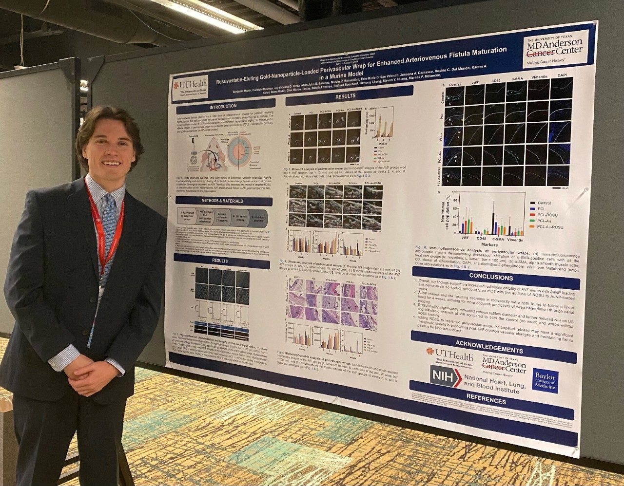 A man stands in front of a poster