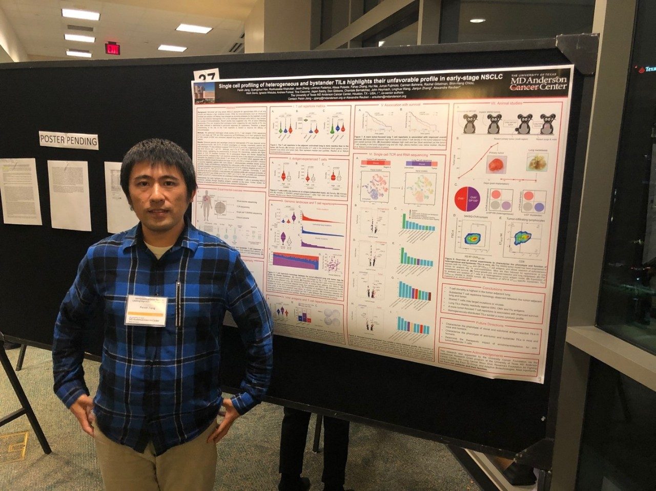 Man in front of a scientific poster
