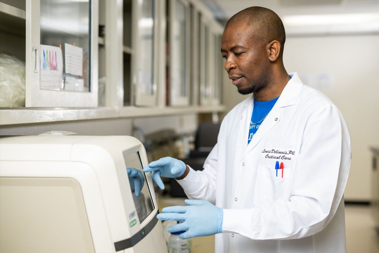 Louis Delinois, Ph.D., works in the lab