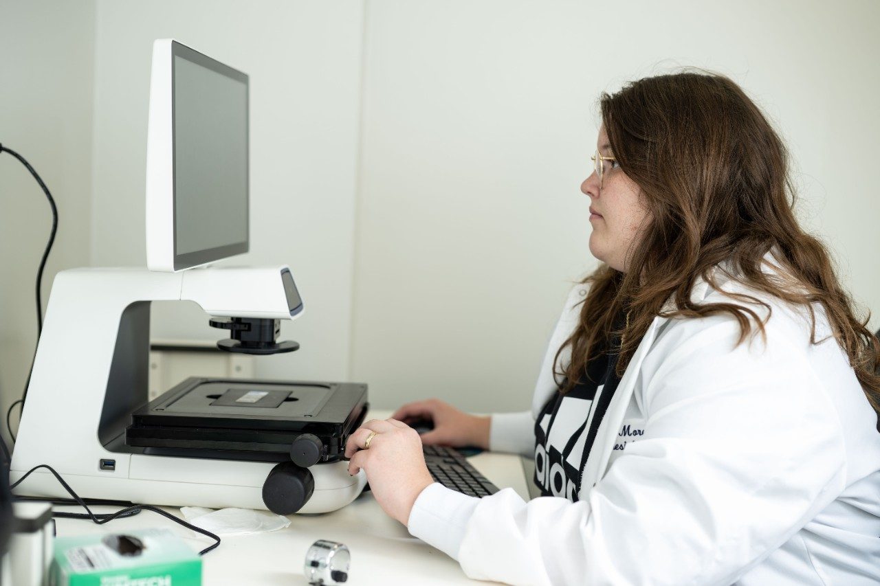Payton Morel, B.S., works in the lab