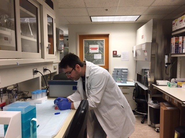 HB prepares a falcon tube for centrifugation